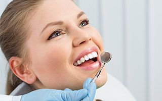 Woman receving dental exam