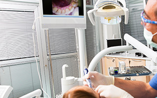 Dentist and patient looking at intraoral photos