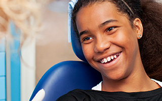 Smiling young girl in dental chair