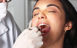 Woman receiving oral cancer screening